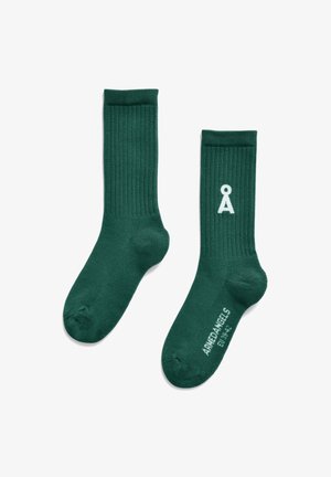 Green cotton socks with ribbed texture, featuring a white logo on the side and reinforced toe and heel areas.