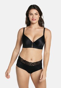 Zwarte bh van glad satijnen stof met kantaccenten, voorzien van verstelbare bandjes en een haaksluiting. Hoge zwarte slip met kantafwerking.