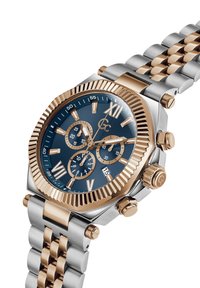 Srebrny i różowo-złoty zegarek chronograf z granatową tarczą, teksturowaną bezelem oraz stalową bransoletą. Posiada wyraźne indeksy godzinowe oraz sub-tarczki.