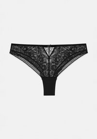 String noir en dentelle avec des motifs floraux, devant transparent et dos opaque. Comprend un petit nœud en accent au centre devant.