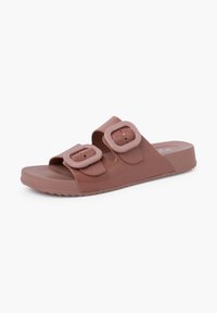 Pink rubber slide sandal with dual adjustable buckle straps, flat sole, and textured bottom for grip. Simple design, smooth finish.