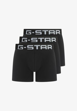 Schwarze Baumwoll-Boxershorts mit G-STAR-Logo auf dem elastischen Bund. Drei Paare ausgestellt, von denen jedes eine enganliegende Form und eine glatte textur aufweist.