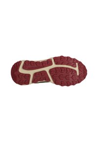 Sko sål med en tekstureret rød gummioverflade, der har et distinkt dækmønster og en cremefarvet mellemsål. Mærket med "ENDURANCE."