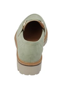 Grön mocka sko med rund tå och bakre dragkedjedetalj, med en beige gummisula och en slät inredningsfoder.