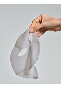 Hydrogel face mask in translucent white material, featuring an eye and mouth opening, with a smooth texture and flexible design.