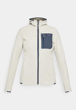 Cream textured jacket with front zipper, blue zippered chest pocket, and hood.
