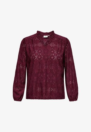 Burgundia pitsim vest, millel on volangserv ja pikad varrukad, samuti keerukad lõikehad kõikjal kangas. V-kaelus.