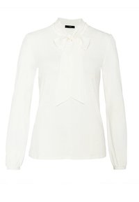 Vit långärmad blus med hög nacke och en slinga knuten vid kragen, med något samlade manschetter.