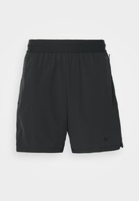 Short de sport noir avec taille élastique, poches latérales et petit logo Nike près de l'ourlet sur fond uni.