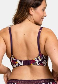 Soutien-gorge multicolore avec un motif floral, bretelles ajustables violettes et fermeture à agrafe à l'arrière. Matière douce avec des bordures en dentelle.