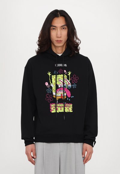 Black hoodie featuring a colorful SpongeBob graphic with the text "NOT AFRAID TO BE SQUARE," adjustable drawstrings, and ribbed cuffs.