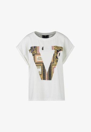 White short-sleeve t-shirt featuring a large patterned "V" graphic in gold, pink, and black, with a smooth, cotton-like texture.