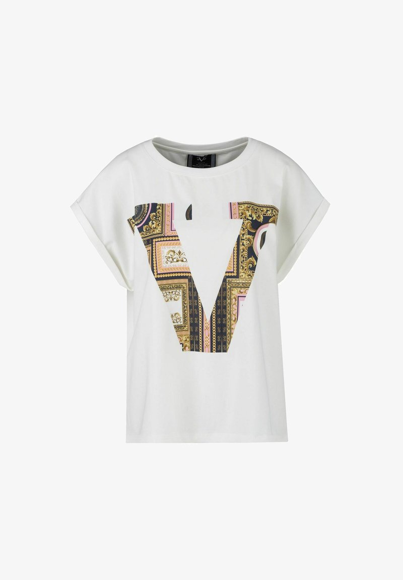 White short-sleeve t-shirt featuring a large patterned "V" graphic in gold, pink, and black, with a smooth, cotton-like texture.