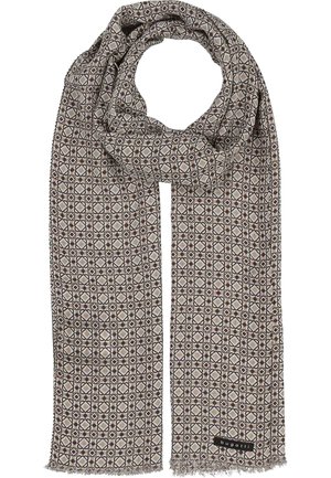 Beige scarf with repeating geometric diamond and square pattern in black and white, folded in a loop with a small fabric label.
