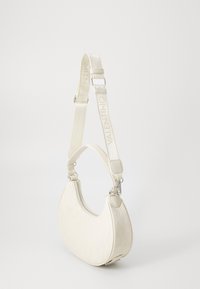 White leather shoulder bag with a curved shape, embossed logo pattern, and adjustable strap featuring "VALENTINO" in a light shade.