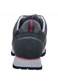 Gray suede athletic shoe with a padded collar, white and pink accents, rugged black outsole, and a two-tone back loop.