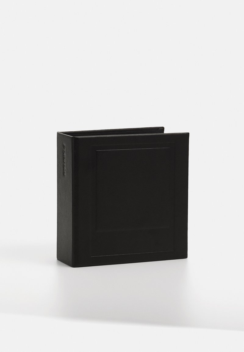 Black leather book with a rectangular shape, featuring a textured surface and a subtle embossed design on the cover.