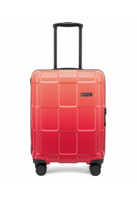 Valigia rigida in gradiente da corallo a rosso, con una texture a griglia, zip nera e ruote per il trasporto. Manico retrattile.