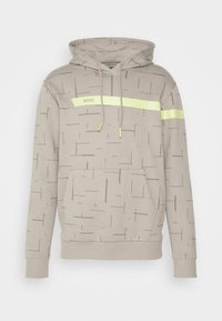 Beige hoodie med ett texturerat mönster av tunna linjer, med en grön logotyp och ett neongrönt horisontellt rand över bröstet.