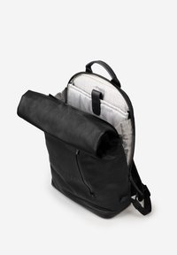 Black backpack with a roll-top closure, showing a lined interior with compartments. Features a durable leather exterior and adjustable straps.