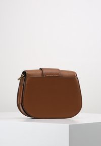 Brunt lädercrossbody-väska med en strukturerad form, med en övre rem och detaljer i guldton. Texturerad yta med logodetalj.