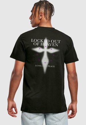 Black cotton t-shirt featuring text "LOCKED OUT OF HEAVEN" and "LONG FOR PEACE" with a white cross and purple stars on the back.