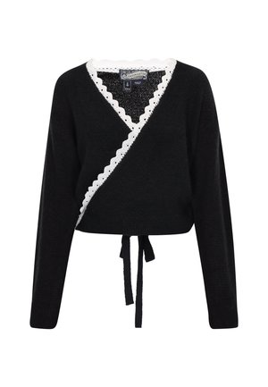 Black wrap sweater with a textured finish, white scalloped trim along the neckline, and a tie at the waist for adjustable fit. Long sleeves.