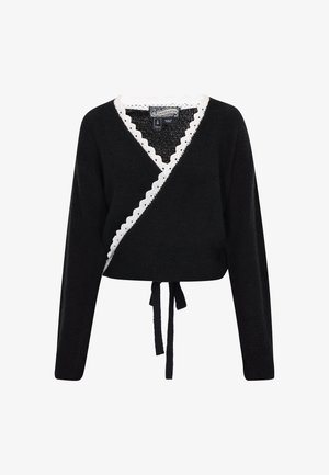 Black wrap sweater with a textured finish, white scalloped trim along the neckline, and a tie at the waist for adjustable fit. Long sleeves.