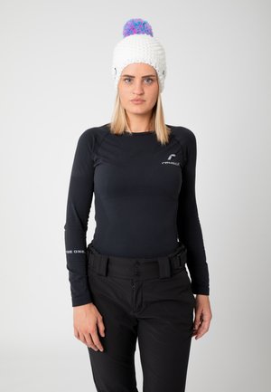 Black long-sleeve base layer top with textured design, paired with black pants featuring a belt. White knitted beanie with colorful pom-pom.