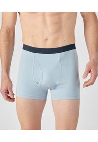 Boxer blu chiaro con un design aderente, vita elasticizzata blu navy, apertura frontale e texture liscia. Nessun motivo visibile o dettagli metallici.