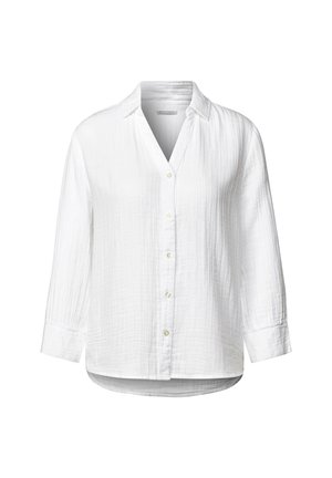 Camicia bianca a maniche lunghe con bottone frontale, colletto e un tessuto leggermente texture. Orlo e polsini arrotondati.