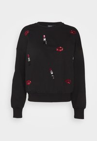 Musta collegepaita, jossa on kirjailtuja punaiset huulet ja huulipuna. Pitkät hihat ja rento istuvuus, jossa resorivyötärö.