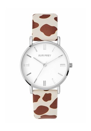 Silver analog wristwatch with white dial, minimal hour markers, and brown cow print leather strap, brand name "SURI FREY" on face.