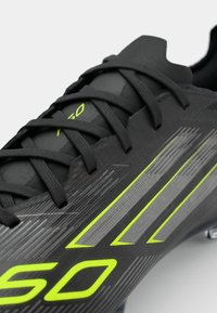 adidas Performance F50 PRO FG - Firm-ground football boots - core black/iron metallic/lucid lemon