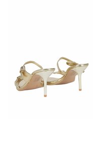 Sandali con tacco alto in oro con finitura metallica, design slingback e cinturini sottili. Presentano un tacco a stiletto sottile e una soletta testurizzata.