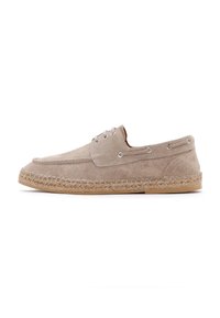 Zapato de esparto de ante beige con punta redonda, dos ojales para cordones y una midsole de yute tejido. Suela de goma plana. Diseño sencillo.