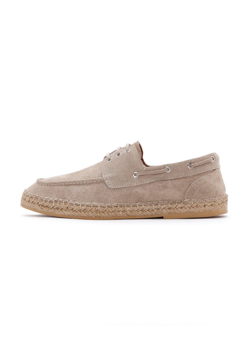 Zapato de esparto de ante beige con punta redonda, dos ojales para cordones y una midsole de yute tejido. Suela de goma plana. Diseño sencillo.