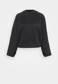 Sweat-shirt noir avec texture côtelée sur les manches, col rond et coupe courte. Comprend un petit logo sur la poitrine. Tissu lisse dans l'ensemble.