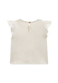 Haut crème à manches courtes avec manches volantées, fermeture à boutons dans le dos, et détail découpé en forme de trou de serrure. Tissu doux avec une texture lisse.