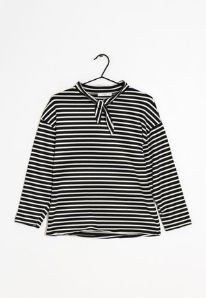 Haut à manches longues rayé noir et blanc avec un col rond et un détail de nœud attaché au col. Fabriqué en tissu doux et lisse.