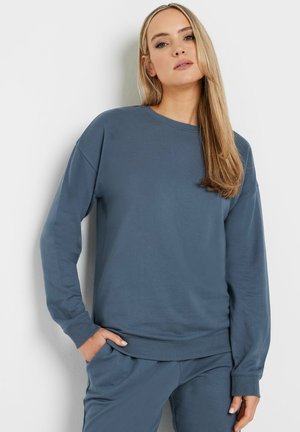 Grijze katoenen sweatshirt met lange mouwen, ronde halslijn, ribgebreide manchetten en zoom. Soepele textuur en een relaxte pasvorm, gecombineerd met bijpassende broek.