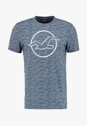 T-shirt blu mélange a maniche corte con il profilo bianco di un uccello in volo all’interno di un cerchio sul petto.