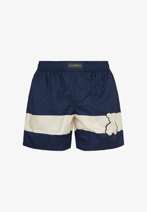 Donkerblauwe zwemshorts met een brede witte horizontale streep en een teddybeer contourlogo op het linkerbeen, elastische tailleband met label "ICEBERG".