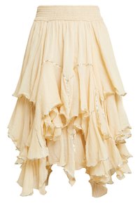 Flared ankle-length skirt in light beige fabric with ruffled tiers and silver stitching accents along the edges. Elastic waist.