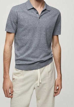 Gray short-sleeve polo shirt with a textured finish, featuring a buttoned placket and a fitted waistband. Worn with light beige pants.