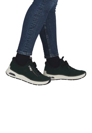 Green suede sneakers with white rubber soles, lace-up design, and grey stitching. Features a side zipper for easy access.