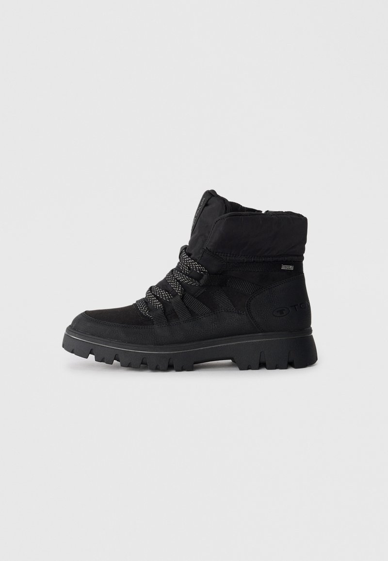 Black ankle boots featuring a textured material, thick sole, and elastic laces. The upper has a padded collar and logo detail on the side.