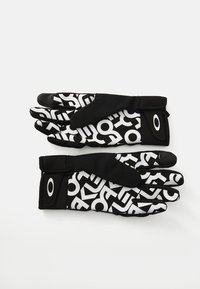Gants noirs avec une surface texturée affichant un motif géométrique blanc contrastant. Tissu extensible avec des sangles réglables pour un ajustement sécurisé.