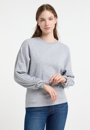 Felpa grigia in materiale morbido con maniche raglan e polsini arricciati. Presenta un collo rotondo e una vestibilità rilassata.