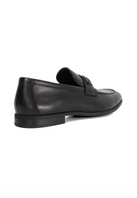 Black leather loafers with a smooth texture, low-profile design, and subtle stitching, featuring a decorative metal accent on the upper.